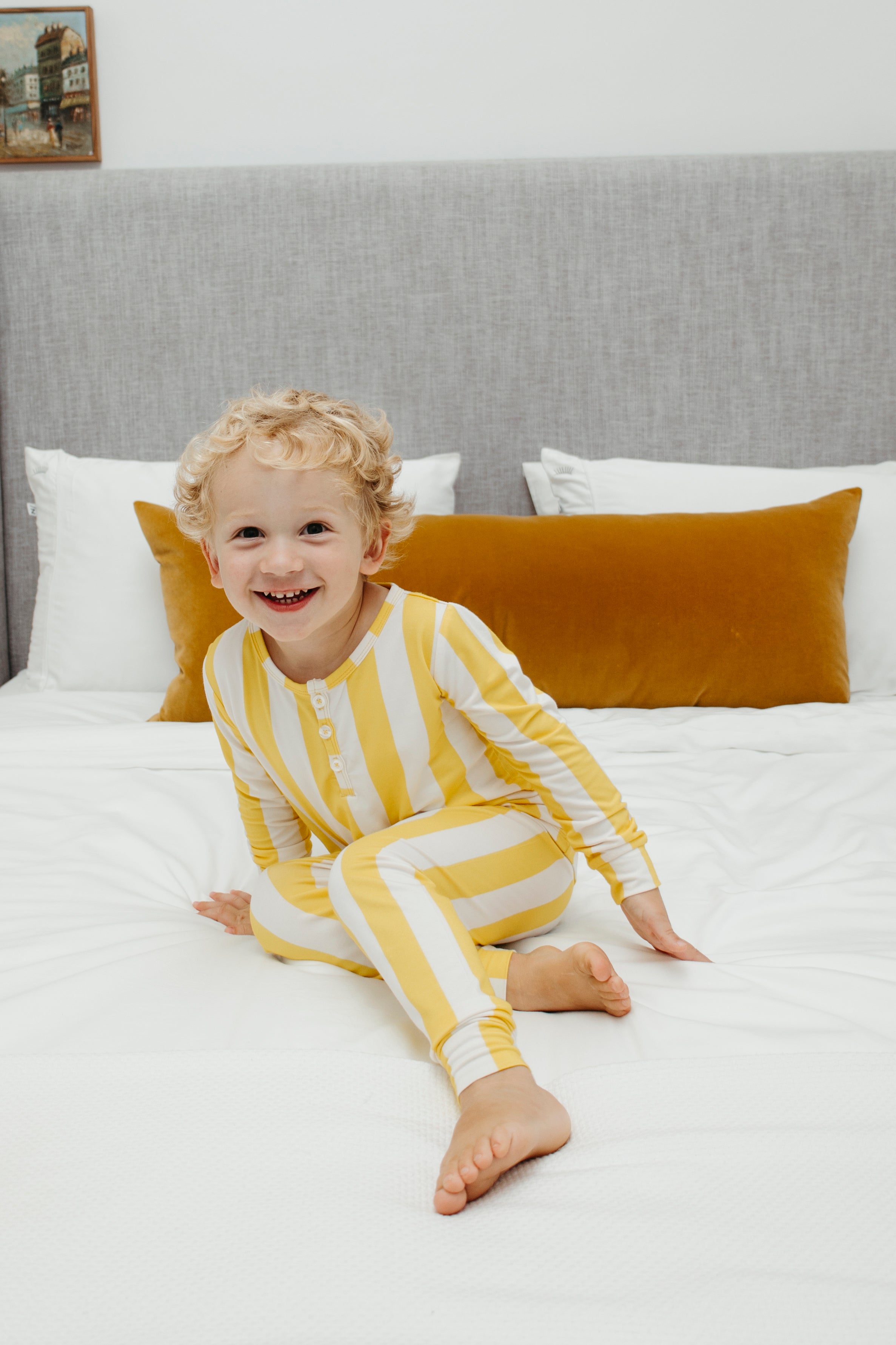 Sunny yellow and white stripe kids pyjamas and plain white bamboo bedding